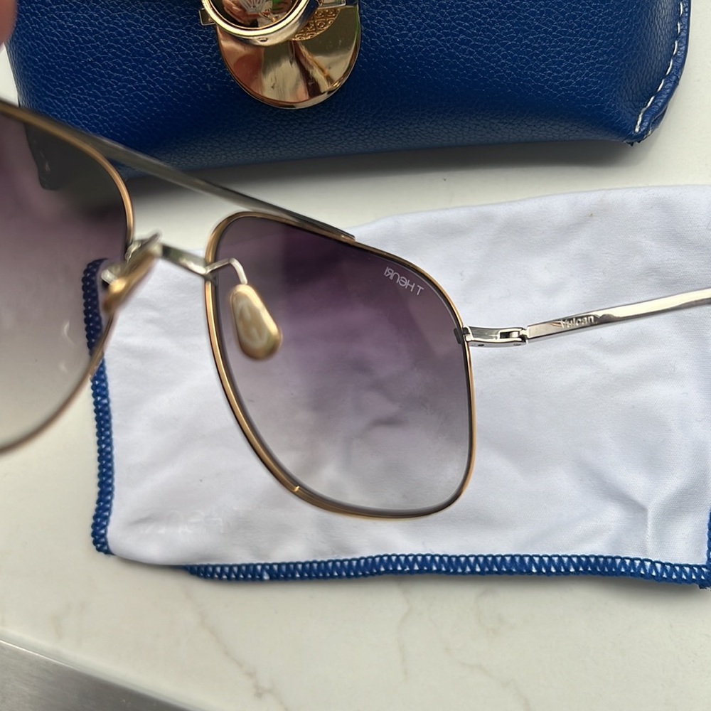 Gold frame sunglasses by THenri